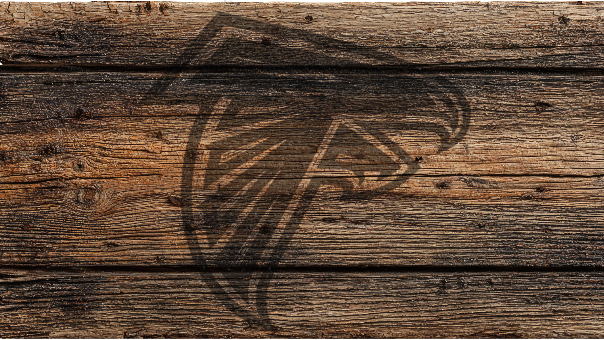 A dark brown Atlanta Falcons logo decal or engraving printed on a rustic, weathered wooden plank background.