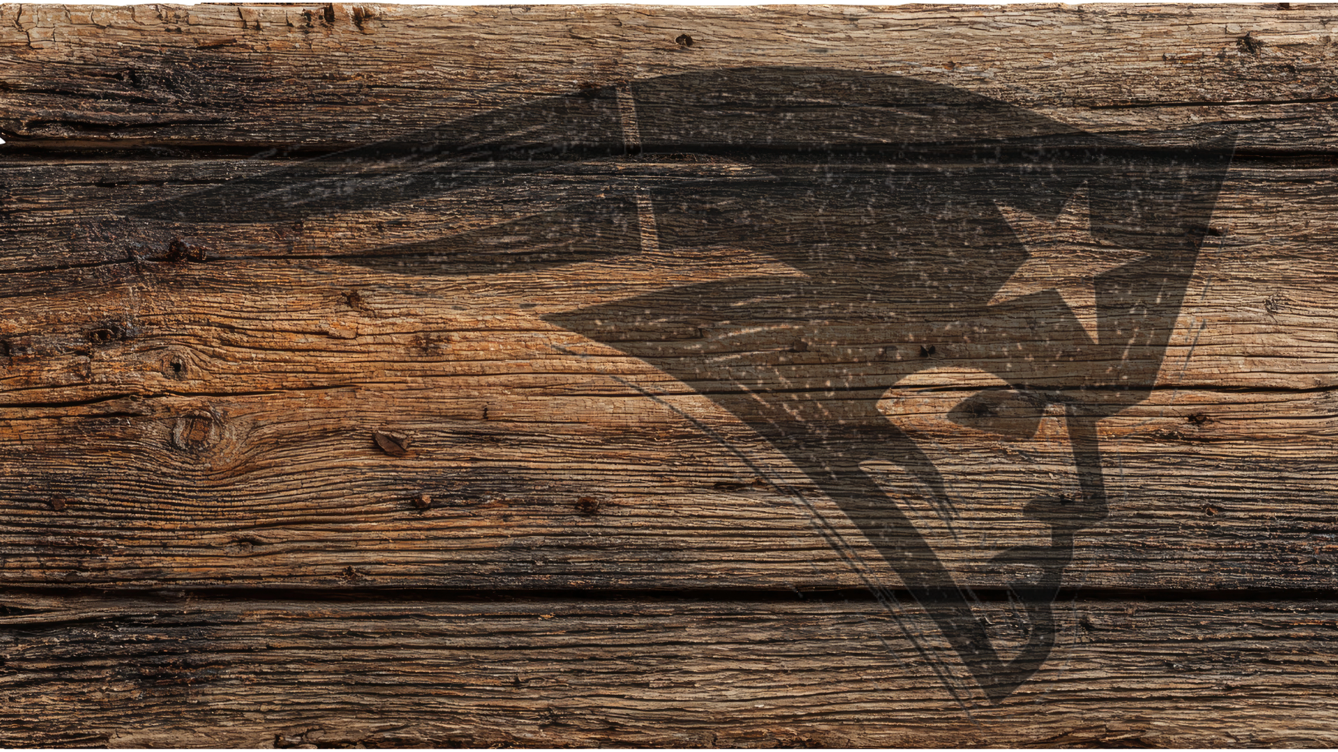 A rustic wooden surface with horizontal planks in weathered brown and black tones, featuring a dark engraved logo silhouette across the right side.