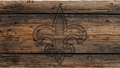 Rustic dark brown wooden plank background with a faded fleur-de-lis emblem centered on the surface.