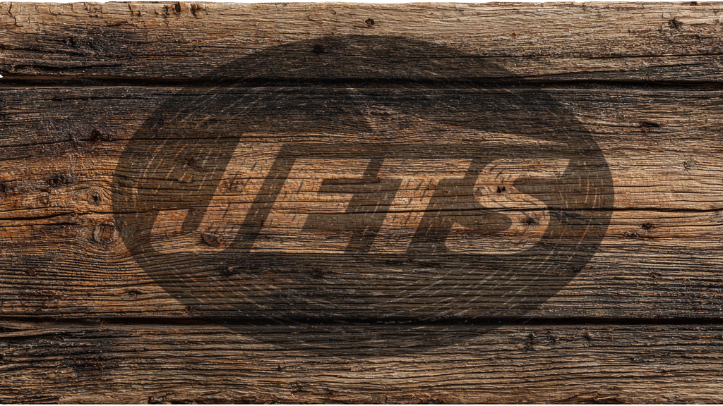 A rustic brown wood plank background with a large dark oval logo containing the word 'Jets' in stylized lettering across the center.